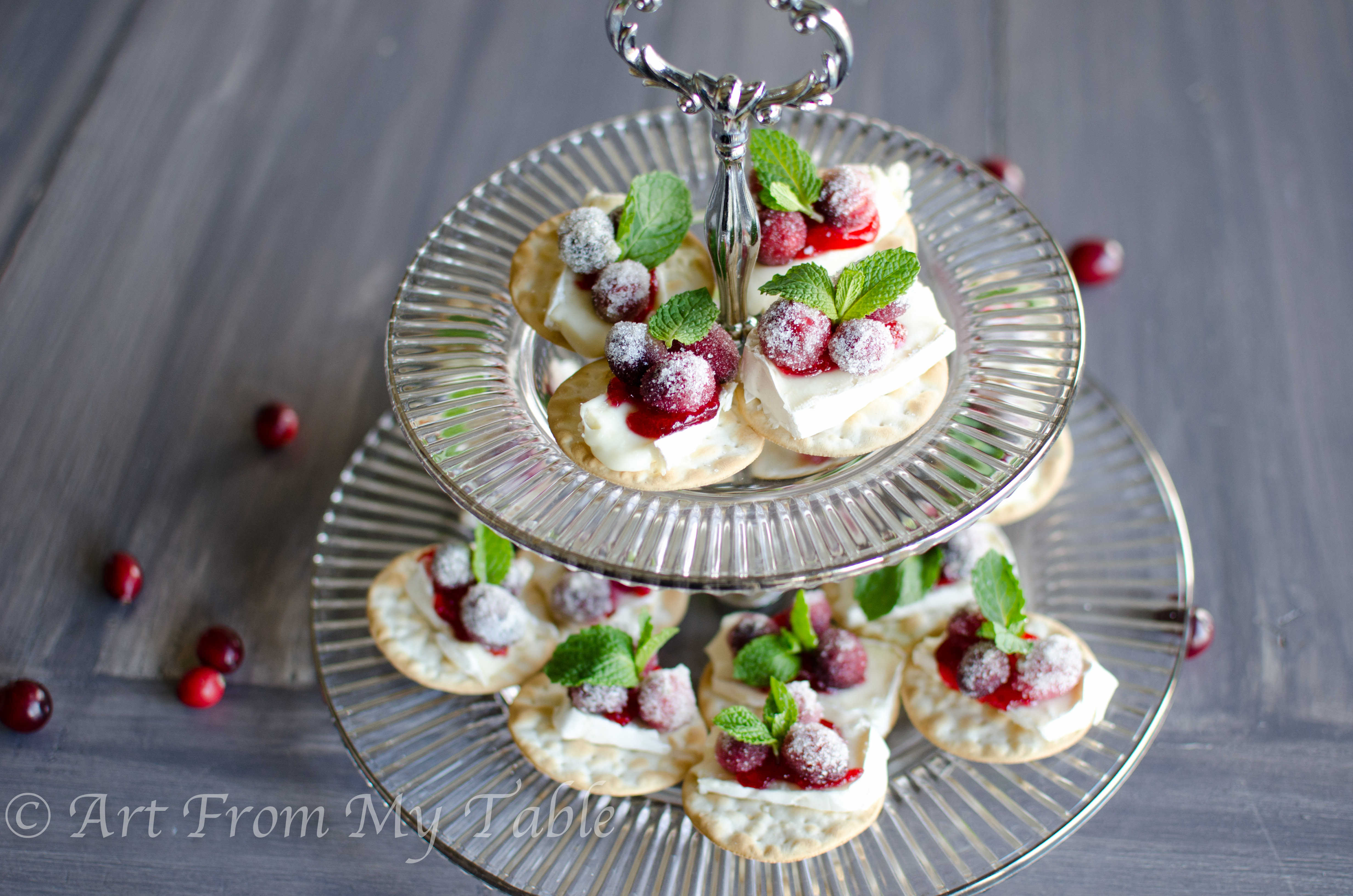 Cranberry brie bites on a tiered tray.
