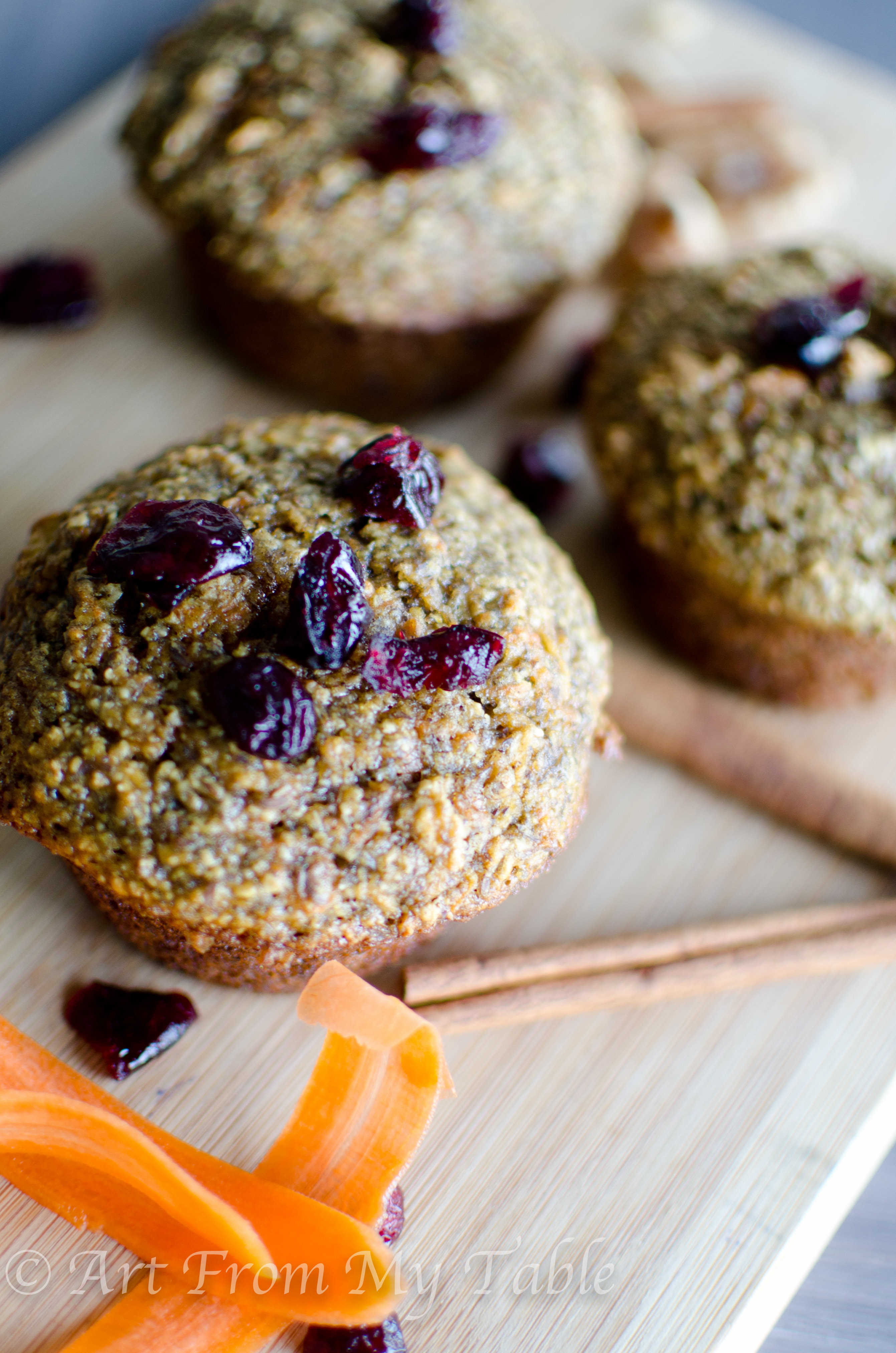 A few bran muffins garnished with dried cranberries.