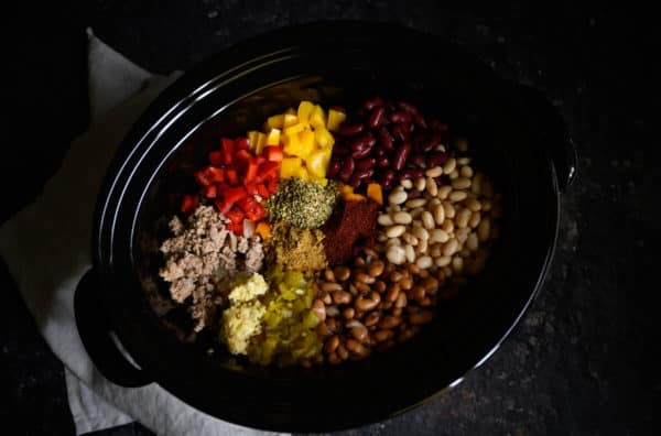 beans, bell peppers, ground turkey, garlic, chili peppers, cumin, oregano, and chili powder in a crockpot.