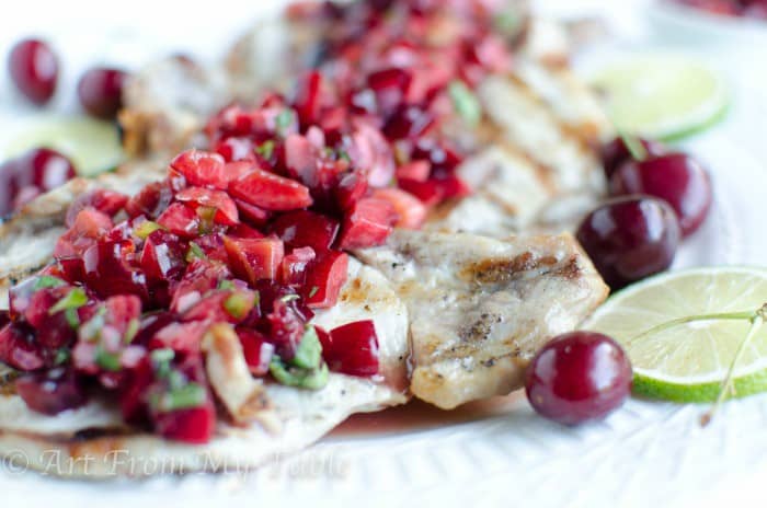 Grilled pork chops with cherry salsa.