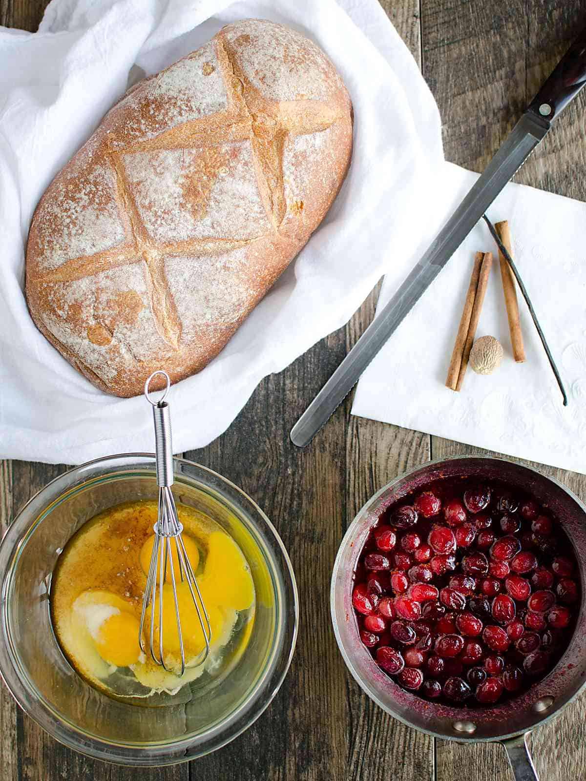 artisan bread, bowl with cracked eggs and egg nog, pan of cranberry syrup.