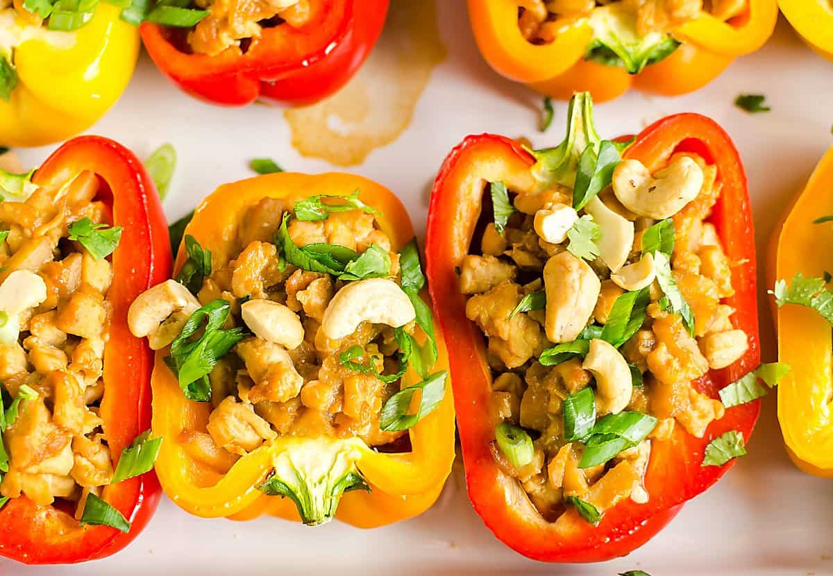 Bell peppers stuffed with Asian chicken and topped with peanuts, cilantro and sliced green onions