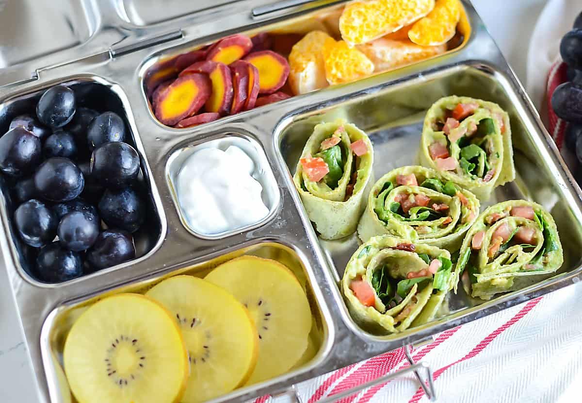 Avocado BLT wrap served with fruit and veggies - healthy lunchbox ideas for school