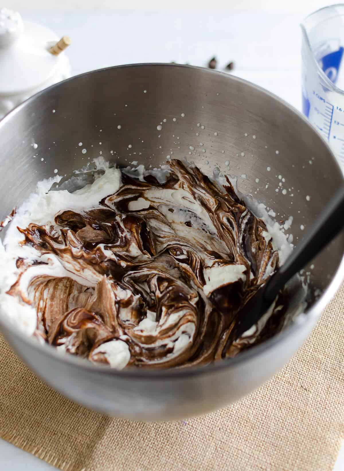 bowl of freshly whipped cream and chocolate mousse lightly stirred with a marble effect