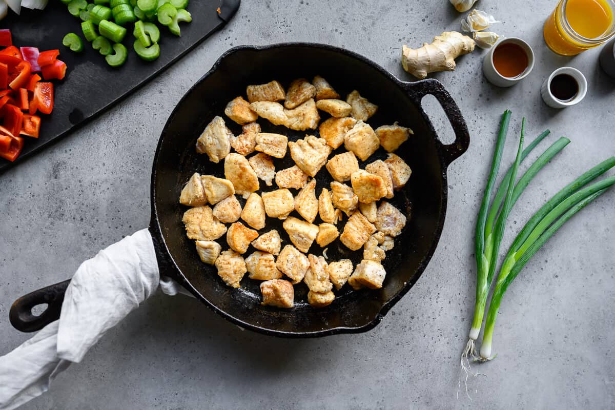 seared chunks of chicken in a cast iron pan