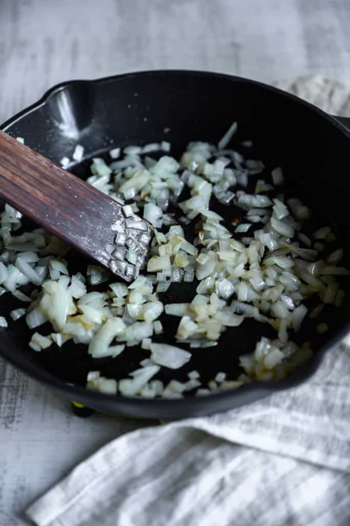 onions being sautéed in a skillet