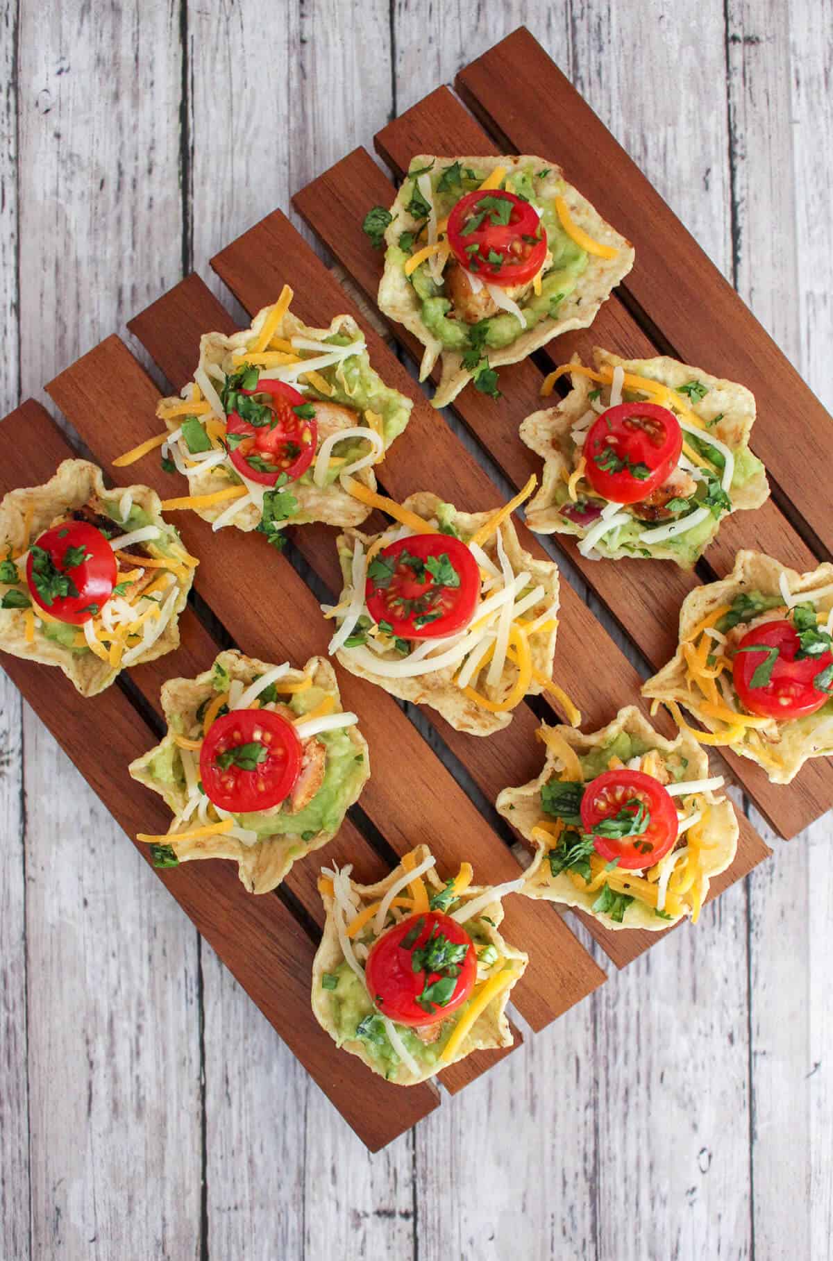tostito 'scoop' tortilla chips filled with chicken, guacamole, cheese and tomato