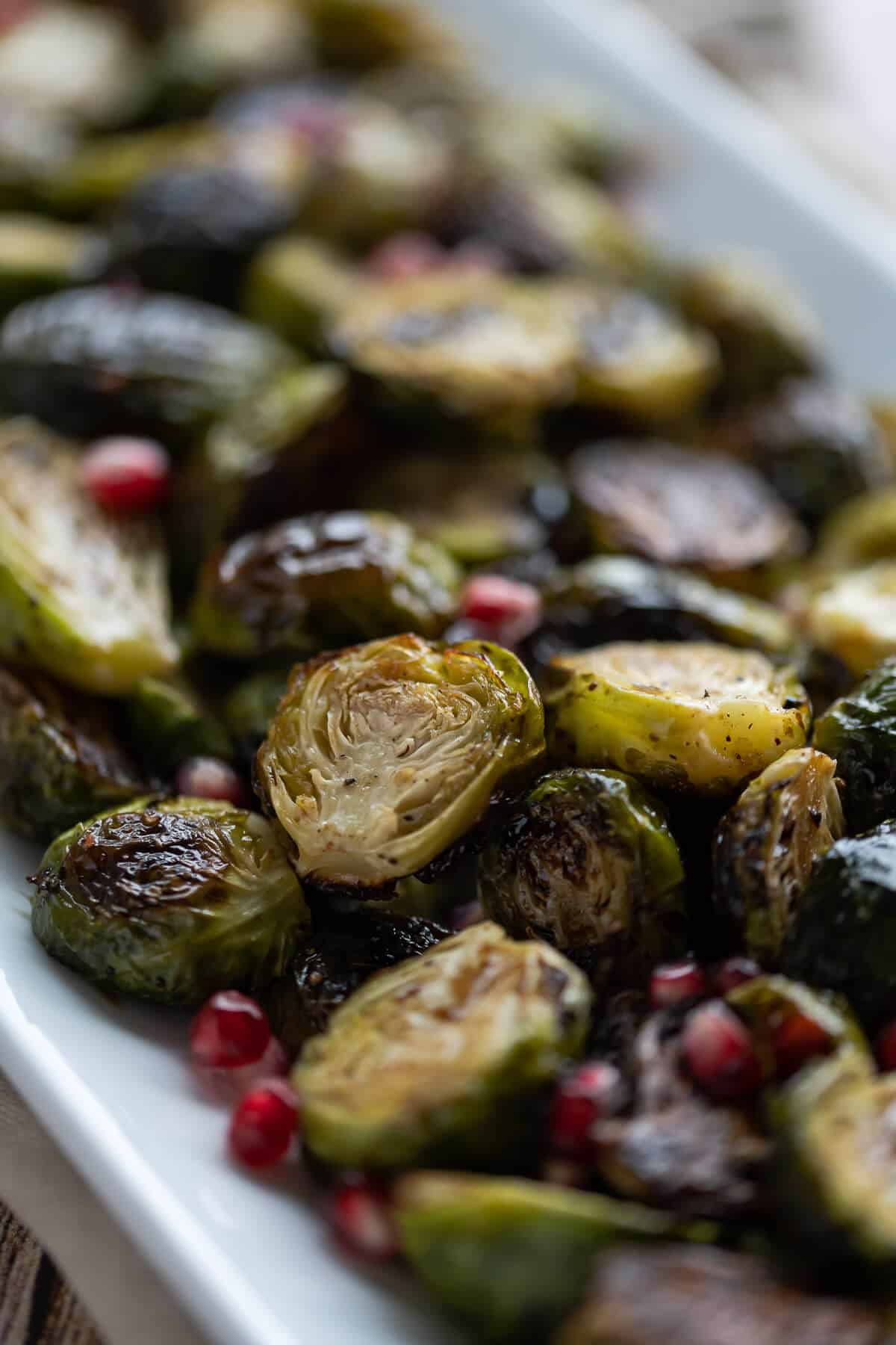 Close up picture of roasted brussels sprouts caramelized on a platter.