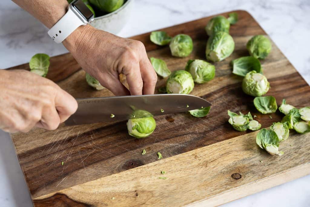 brussels sprout being sliced in half lengthwise