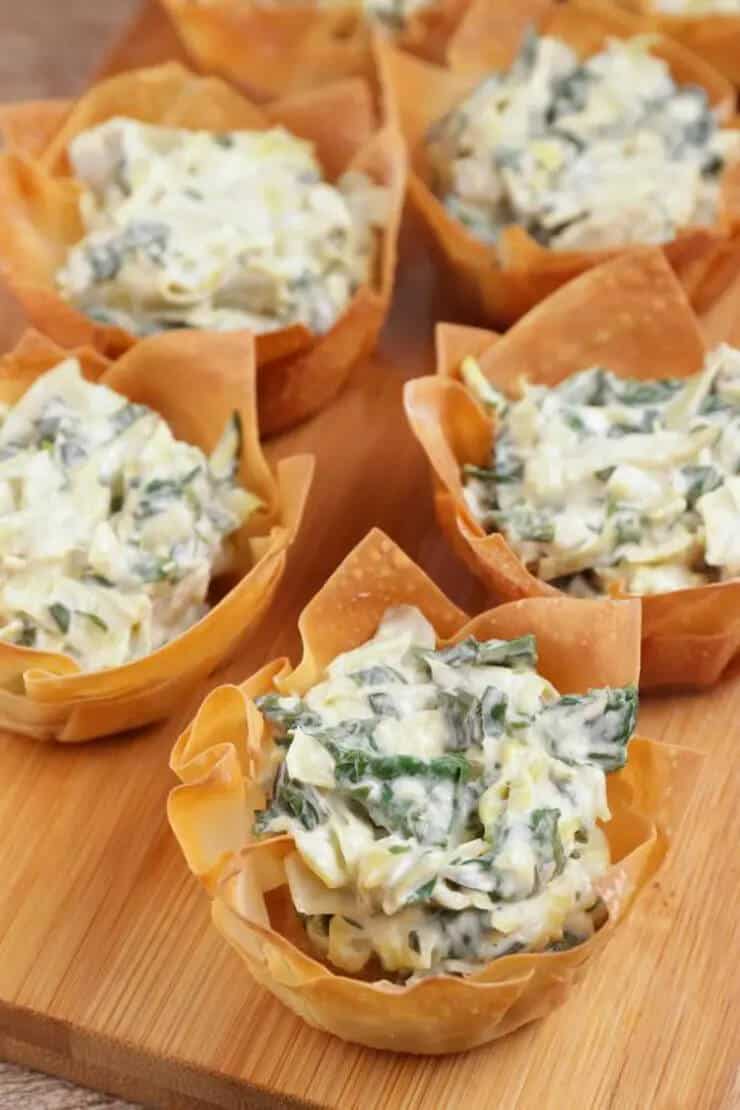 baked wonton cups filled with spinach and artichoke dip