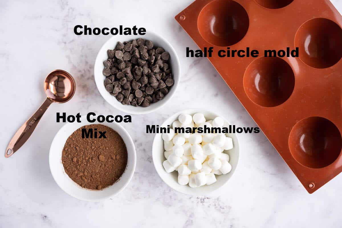 hot cocoa bomb ingredients: chocolate, hot cocoa mix, mini marshmallows, half circle silicone mold