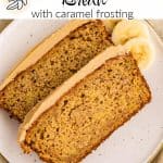 Two slices of banana bread with caramel frosting on a speckled plate, garnished with 3 banana slices on the side.